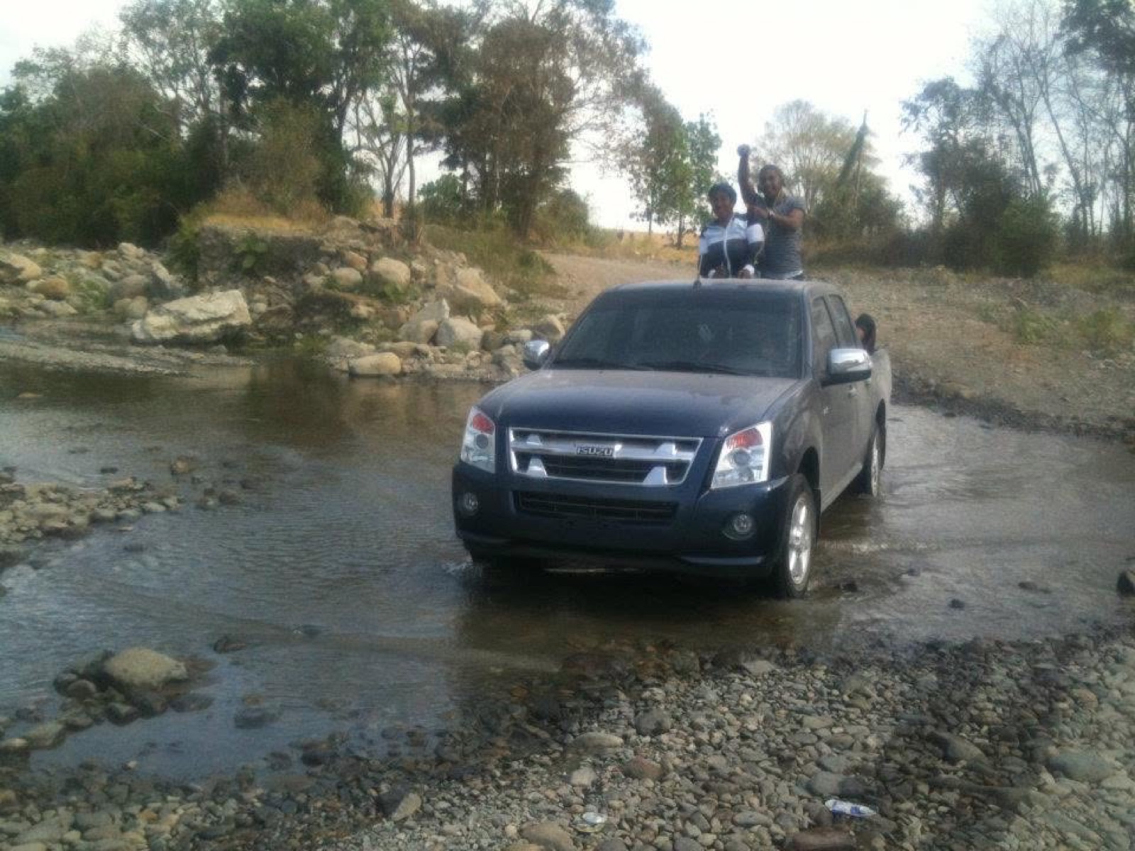 Vehicle fording a river on the route to a rural Panama community