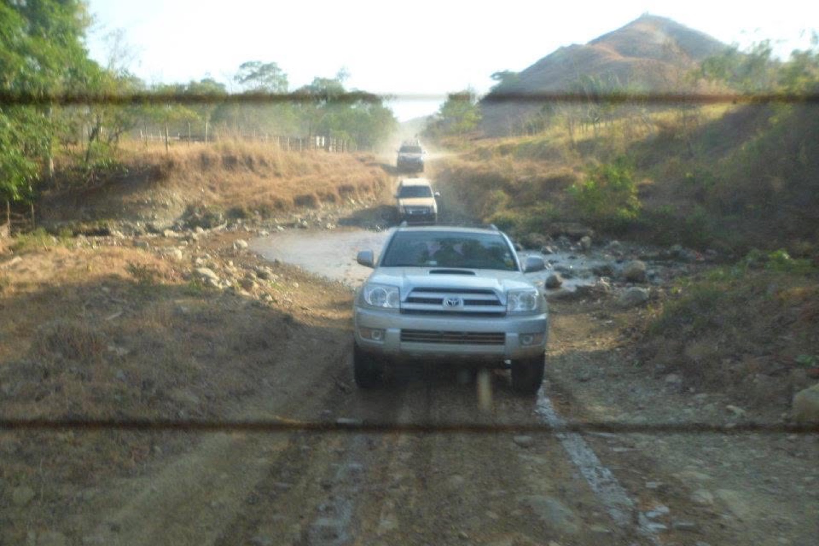 Vehicles traveling through difficult rural terrain in Panama